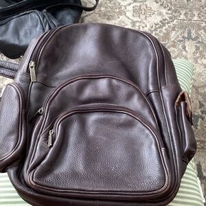 Heavy duty leather backpack with laptop compartment. Dark brown.